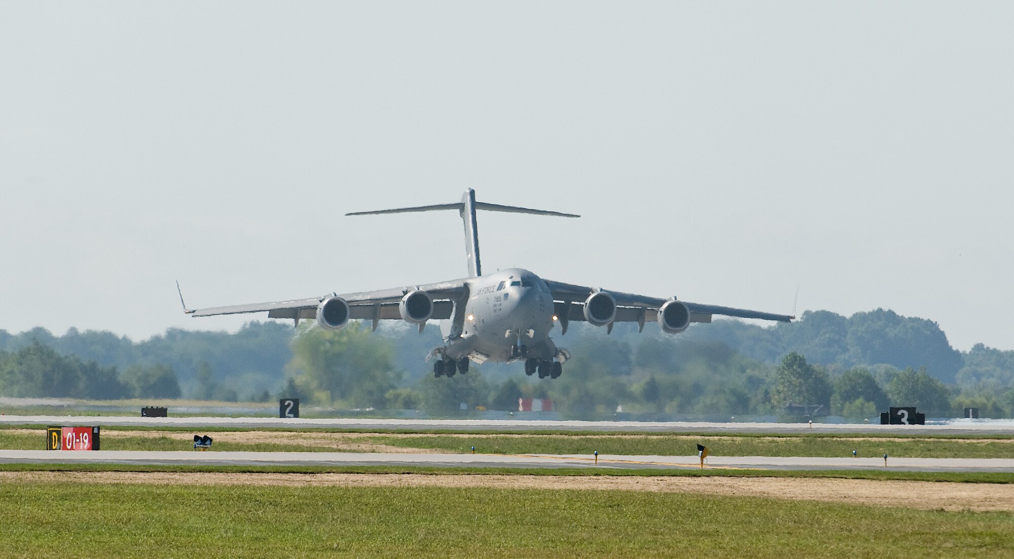 A C-17A Globemaster III flies feet above Runway 01-19 prior to landing Sept. 23, 2016, at Dover Air Force Base, Del. Following the landing of a C-5M Super Galaxy, this Globemaster III was the first C-17A and second aircraft to land on the newly reconstructed runway. (U.S. Air Force photo by Roland Balik)