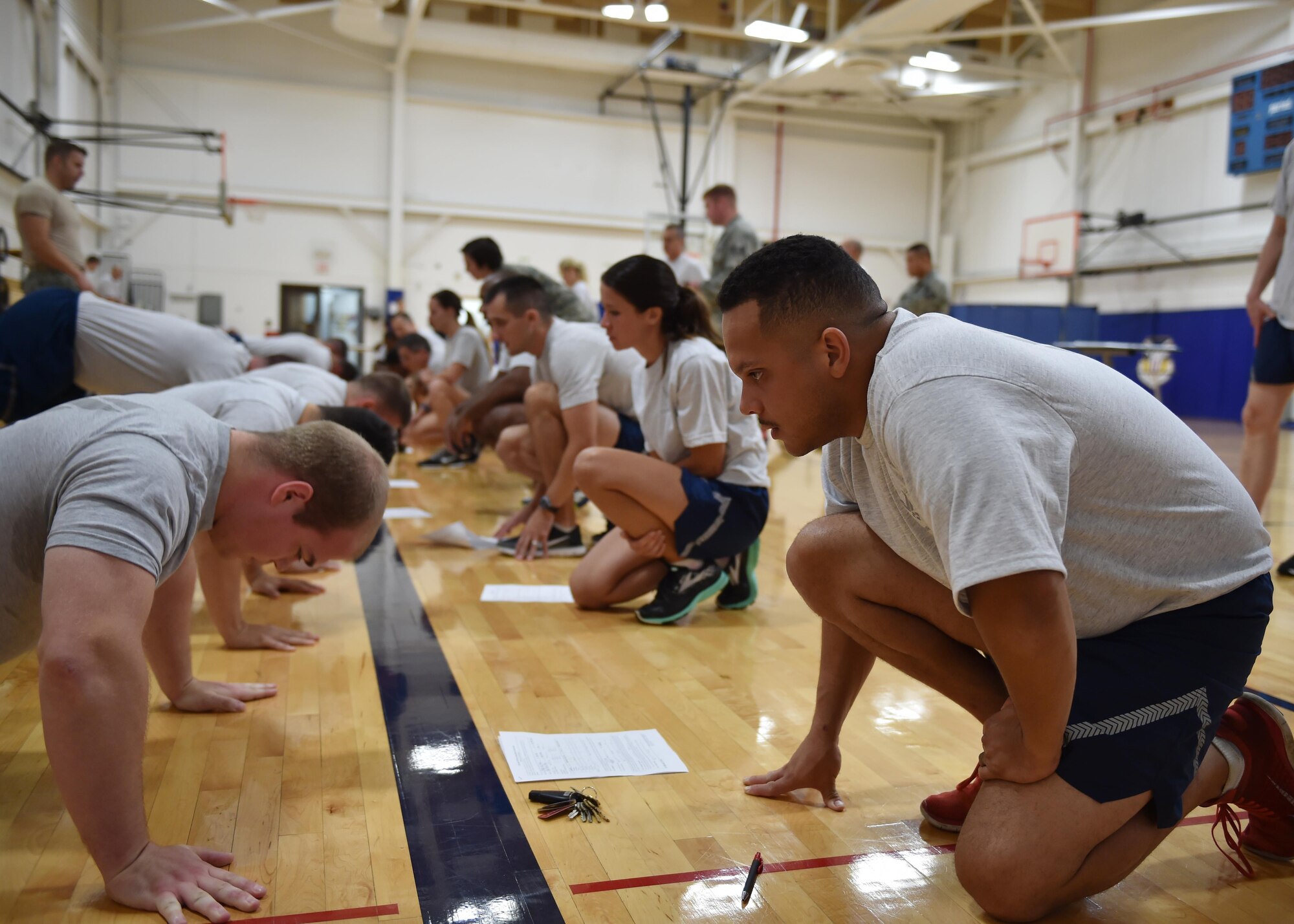 Air Force Reserve Senior Airman Jonathan Torres, a security response team member assigned to the 910th Security Forces Squadron, monitors push-ups for Staff Sgt. Cody Moore, a medical lab technician assigned to the 910th Medical Support Squadron, during his physical training test here Sept. 11, 2016. The physical training test measures physical fitness in the areas of push-ups, sit-ups, abdominal circumference and a mile and half run. (U.S. Air Force photo/Staff Sgt. Rachel Kocin)