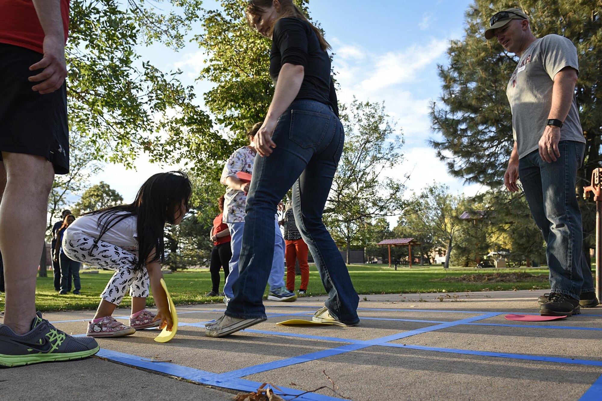PETERSON AIR FORCE BASE, Colo. – Valeria Pfeifer places a dot on the ground during a game of human tic-tac-toe at the Family Fun Night at Lyon’s Park on Peterson Air Force Base, Colo., Sept. 22, 2016. The event was put on by the Health and Wellness Center to bring attention to Childhood Obesity Awareness Month and ways to live a healthier lifestyle. (U.S. Air Force photo by Senior Airman Rose Gudex)