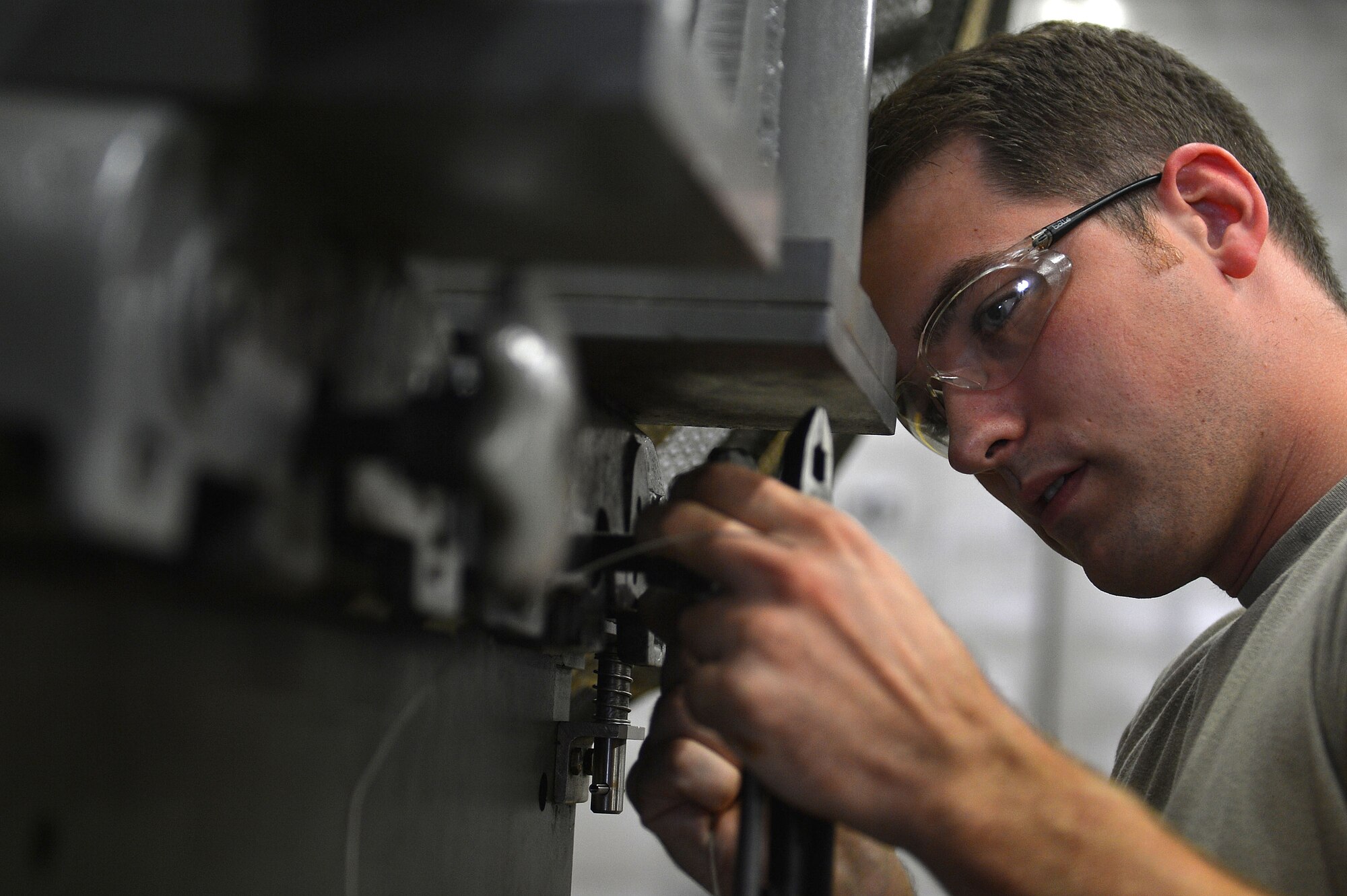 U.S. Air Force Senior Airman Jared Erickson, 20th Component Maintenance Squadron aerospace propulsion journeyman replaces a bolt on an F-16CM Fighting Falcon engine at the 20th CMS engine test facility at Shaw Air Force Base, S.C., Sept. 26, 2016. Erickson performed the repair to ensure that the engine will function properly. (U.S. Air Force photo by Airman 1st Class Christopher Maldonado)