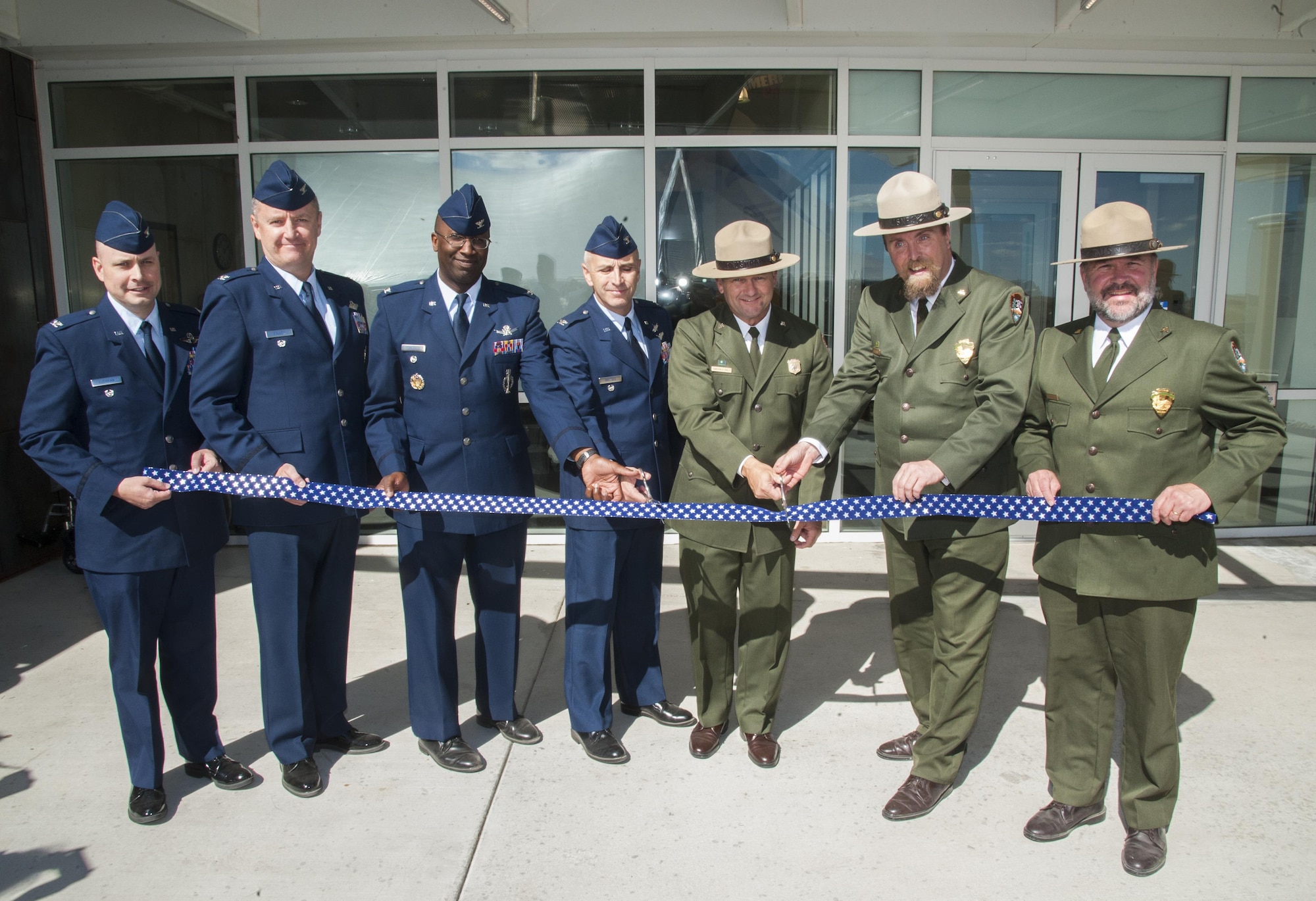 Leaders from Air Force Global Strike Command and 20th Air Force perform a ribbon-cutting ceremony with National park rangers celebrating the grand opening of the new Minuteman Missile National Historic Site visitor center in Philip, S.D. on Sept. 24, 2016. The visitor center helps recognize nuclear missile silos that were strategically placed throughout the Great Plains during the heat of the Cold War to maintain peace and prevent war. (U.S Air Force photo by Airman 1st Class Christian Sullivan)   