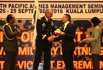 Gen. Robert B. Brown, Commander, U.S. Army Pacific and Lt. Gen. Dato’ Sri Zulkiple, Field Commander West, Malaysian Army present a memento to the Honorable Dato’ Seri Hishmuddin, Minister of Defence Malaysia during the opening ceremony for PAMS 2016, in Kuala Lumpur, Malaysia, September 26. PAMS is an annual multinational military seminar providing a forum for senior level ground force officers from regional ground forces and security forces to meet, exchange views and discuss professional military subjects. This year’s theme is "Unity of Effort: Building Civil-Military Partnerships to Counter Violent Extremism." This seminar marks the 40th iteration of PAMS.