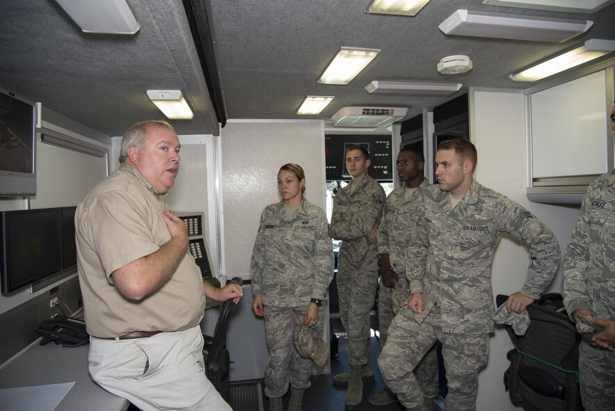 Kevin Sibble, Kent County Department of Public Safety assistant director, briefs airmen assigned to the 436th Airlift Wing Command Post aboard the county’s mobile incident command vehicle Sept. 22, 2016, on Dover Air Force Base, Del. The vehicle can be used to set up a temporary command and control center anywhere in the state. (U.S. Air Force photo by Senior Airman Aaron J. Jenne)