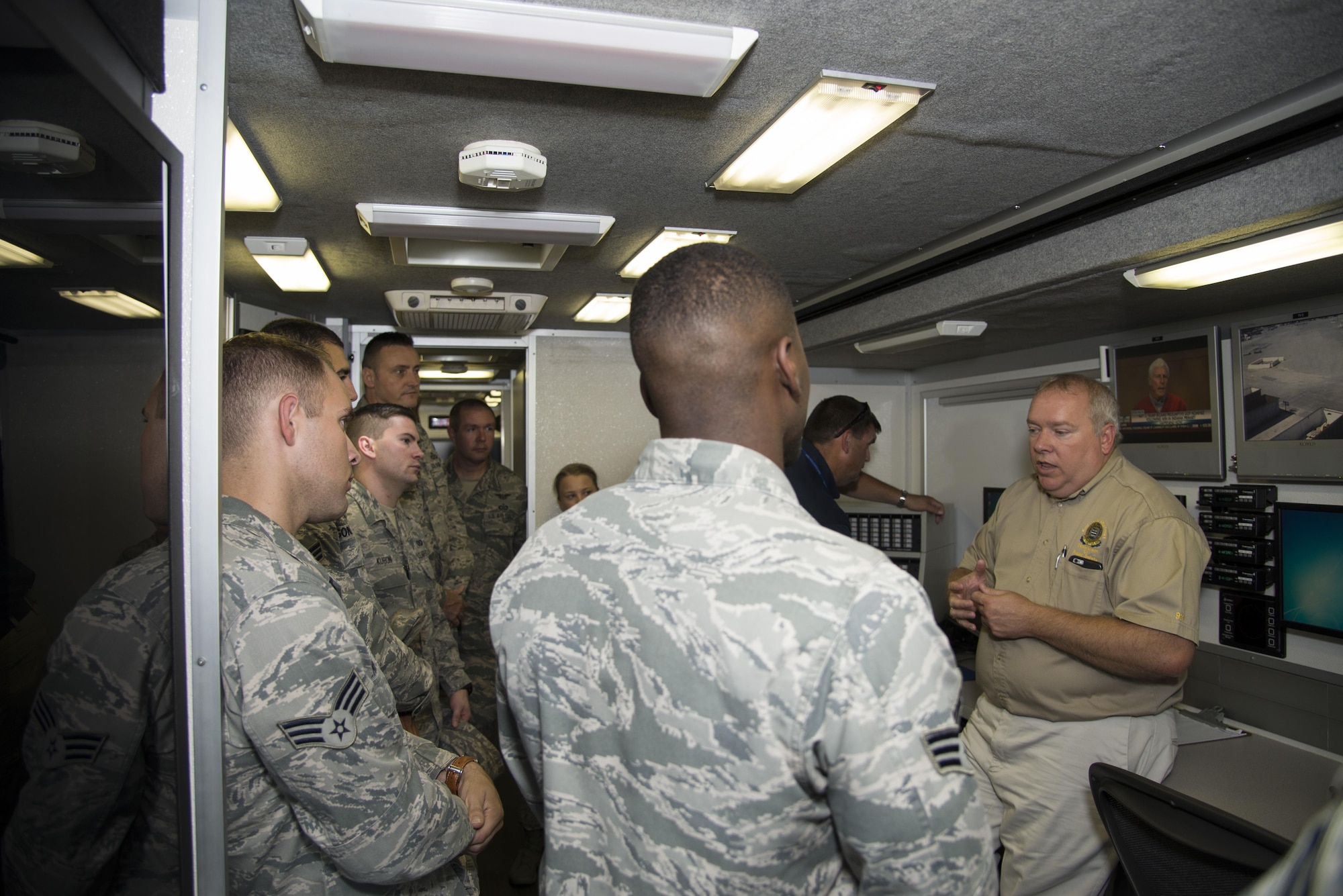 Airmen assigned to the 436th Airlift Wing Command Post listen to Kevin Sibble, Kent County Department of Public Safety assistant director, Sept. 22, 2016, on the county’s mobile incident command vehicle parked on Dover Air Force Base, Del. From the vehicle, emergency response controllers can communicate with emergency responders located anywhere in the Delmarva Peninsula. (U.S. Air Force photo by Senior Airman Aaron J. Jenne)