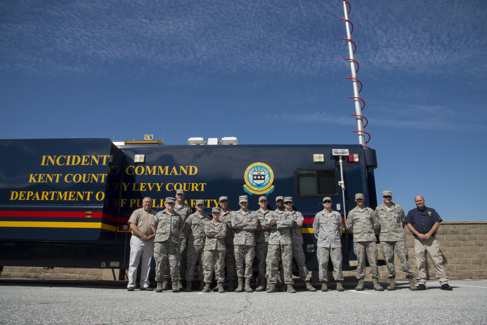 Several of Team Dover’s emergency responders and representatives from the Kent County Department of Public Safety stand in front of the county’s mobile incident command vehicle Sept. 22, 2016, at Dover Air Force Base, Del. The visit was intended to increase awareness of the equipment and capabilities of both the base and community thus strengthening the partnership. (U.S. Air Force photo by Senior Airman Aaron J. Jenne)