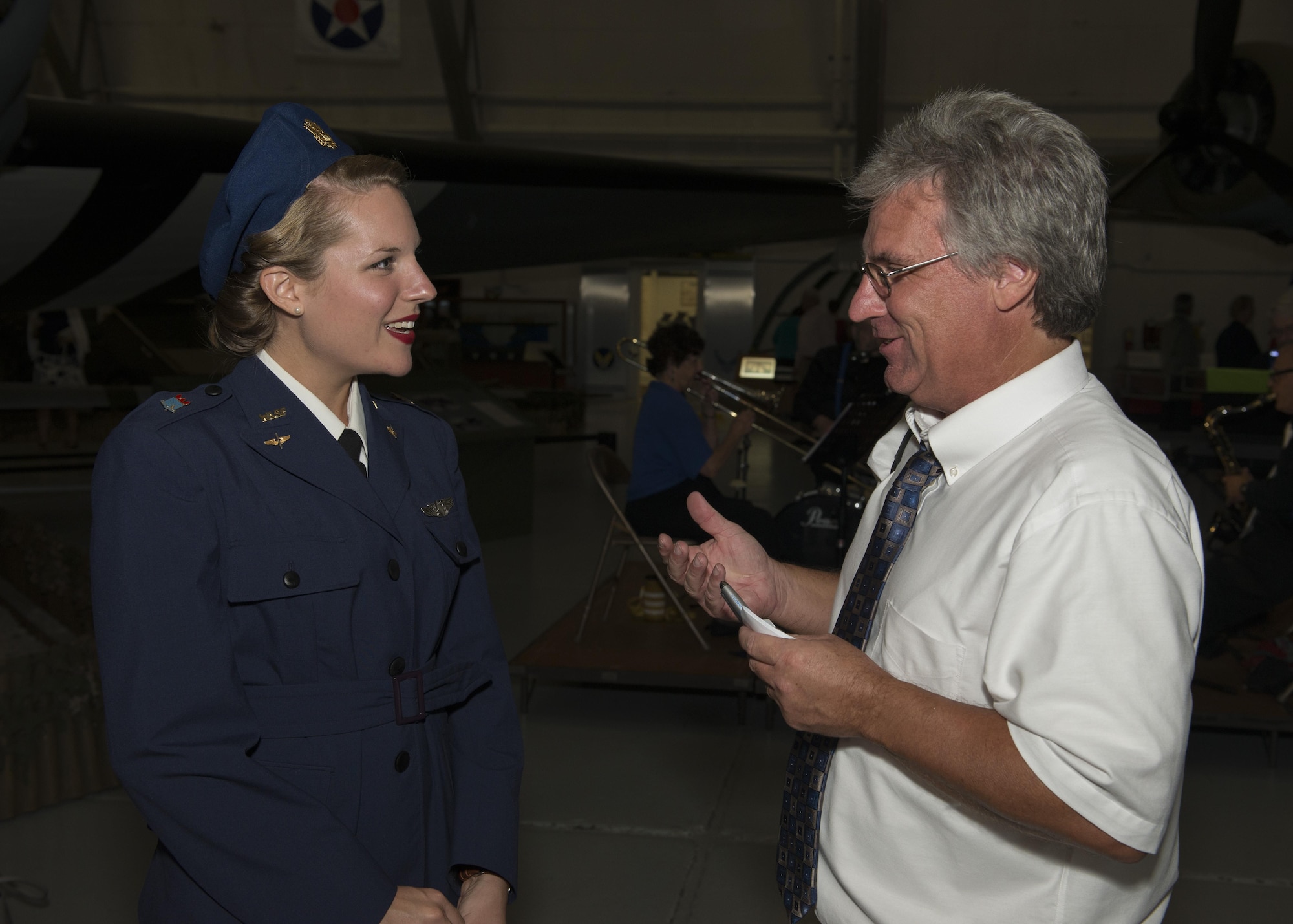 Andrew West, Delaware State News, speaks to Tricia Upchurch, Air Mobility Command Museum educator, who is dressed as a member of the World War II Women Airforce Service Pilots (WASP), during the Festival of Flight Exclusive Party and Raffle Sept. 23, 2016, at the Air Mobility Command Museum on Dover Air Force Base, Del. The event raised about $20,000 for the AMC Museum Foundation. (U.S. Air Force photo by Senior Airman Zachary Cacicia)