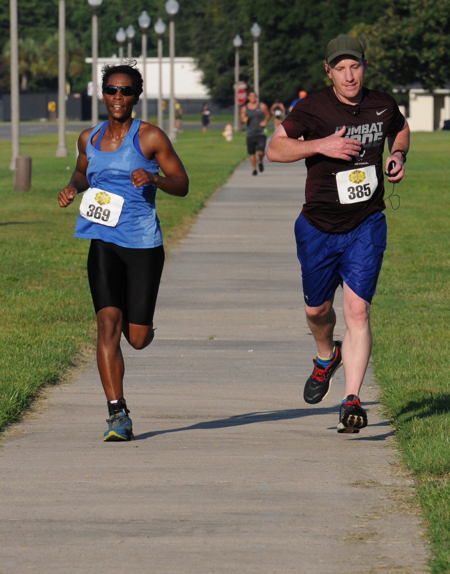 Airman 1st Class Roslyn Lack, 338th Training Squadron student, and Lt. Col. Michael Zink, 338th TRS commander, run the last stretch of the 2-mile run, the final event of Keesler’s mini-triathlon Sept. 23, 2016, on Keesler Air Force Base, Miss. The event also included a 200-yard swim and a 9-mile bike ride.