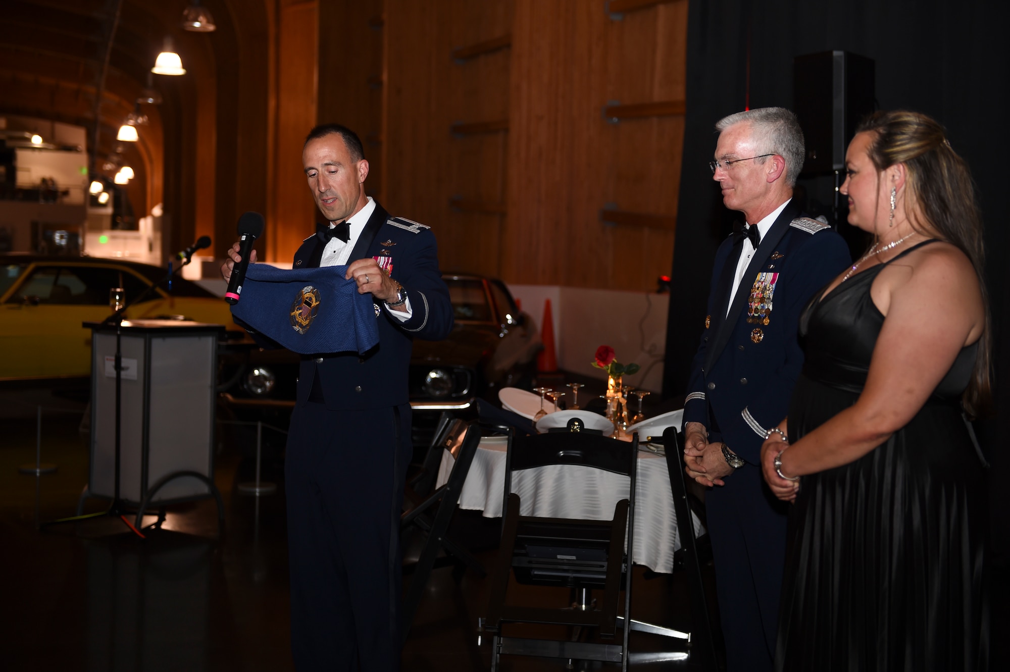 Col. Leonard Kosinksi, 62nd Airlift Wing Commander, and Brenna Johnson, McChord Chapter Air Force Association, present Gen. Paul Selva (center), Vice Chairman of the Joint Chiefs of Staff, with a custom seat cover during the Air Force Ball at the Lemay America’s Car Museum in Tacoma, Wash., Sept. 23, 2016. Selva, who served as a former 62nd Airlift Wing commander, spoke during the event and showed gratitude toward the various community partners who take care of the men and women at McChord. (U.S. Air Force photo/Staff Sgt. Naomi Shipley)