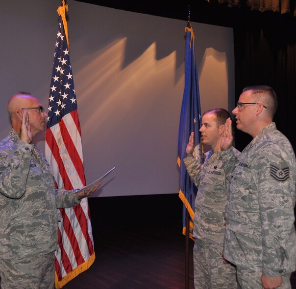Maj. Stan Paregien performs the double ceremony oath of reenlistment for two wing noncommissioned officers, Master Sgt. James Melvin and Tech. Sgt. Christopher Parr, following the September 11th Unit Training Assembly commander's call, held at the 932nd Airlift Wing on Scott Air Force Base, Ill.  Melvin and Parr are members of the wing staff and serve in the United States Air Force Reserve Command under 22nd Air Force.  (U.S. Air Force photo by Tech. Sgt. Jodi Ames)
