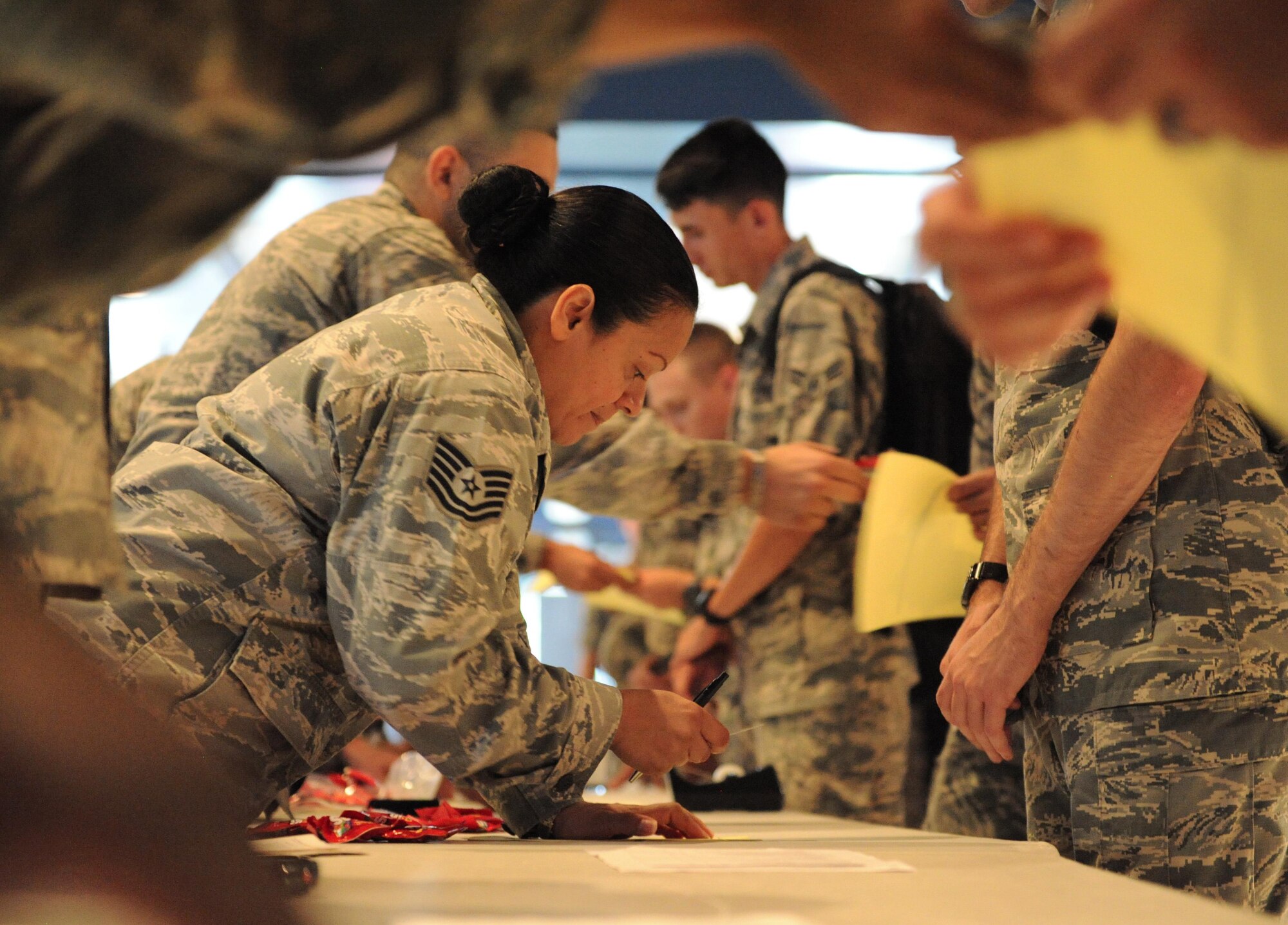 Tech. Sgt. Nilsa Negron, 81st Diagnostic and Therapeutics Squadron pharmacy technician, provides a ‘patient’ medication as they go through the makeshift pharmacy inside Vandenberg Hall during a public health emergency exercise Sept. 22, 2016, on Keesler Air Force Base, Miss. The weeklong exercise tested how the 81st Medical Group responds during a mass sickness outbreak. The 81st MDG staged a point of dispensing to diagnose, discuss treatment plans and provide medicine to sick Airmen.
