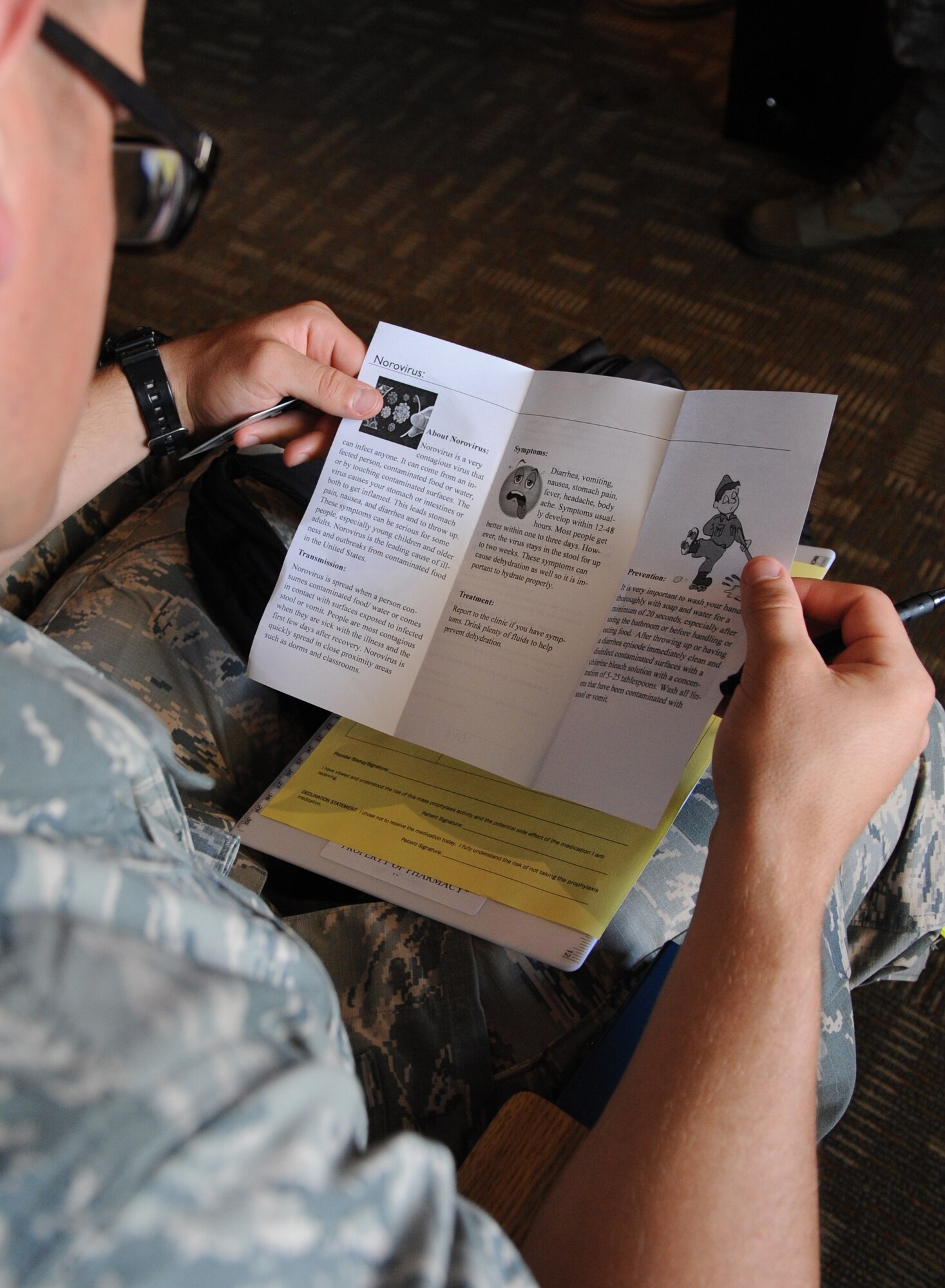 Airman Steven Terwilliger, 336th Training Squadron and exercise ‘patient’, reads a Norovirus information pamphlet during a public health emergency exercise at Vandenberg Hall Sept. 22, 2016, on Keesler Air Force Base, Miss. The weeklong exercise tested how the 81st Medical Group responds during a mass sickness outbreak. The 81st MDG staged a point of dispensing to diagnose, discuss treatment plans and provide medicine to sick Airmen.