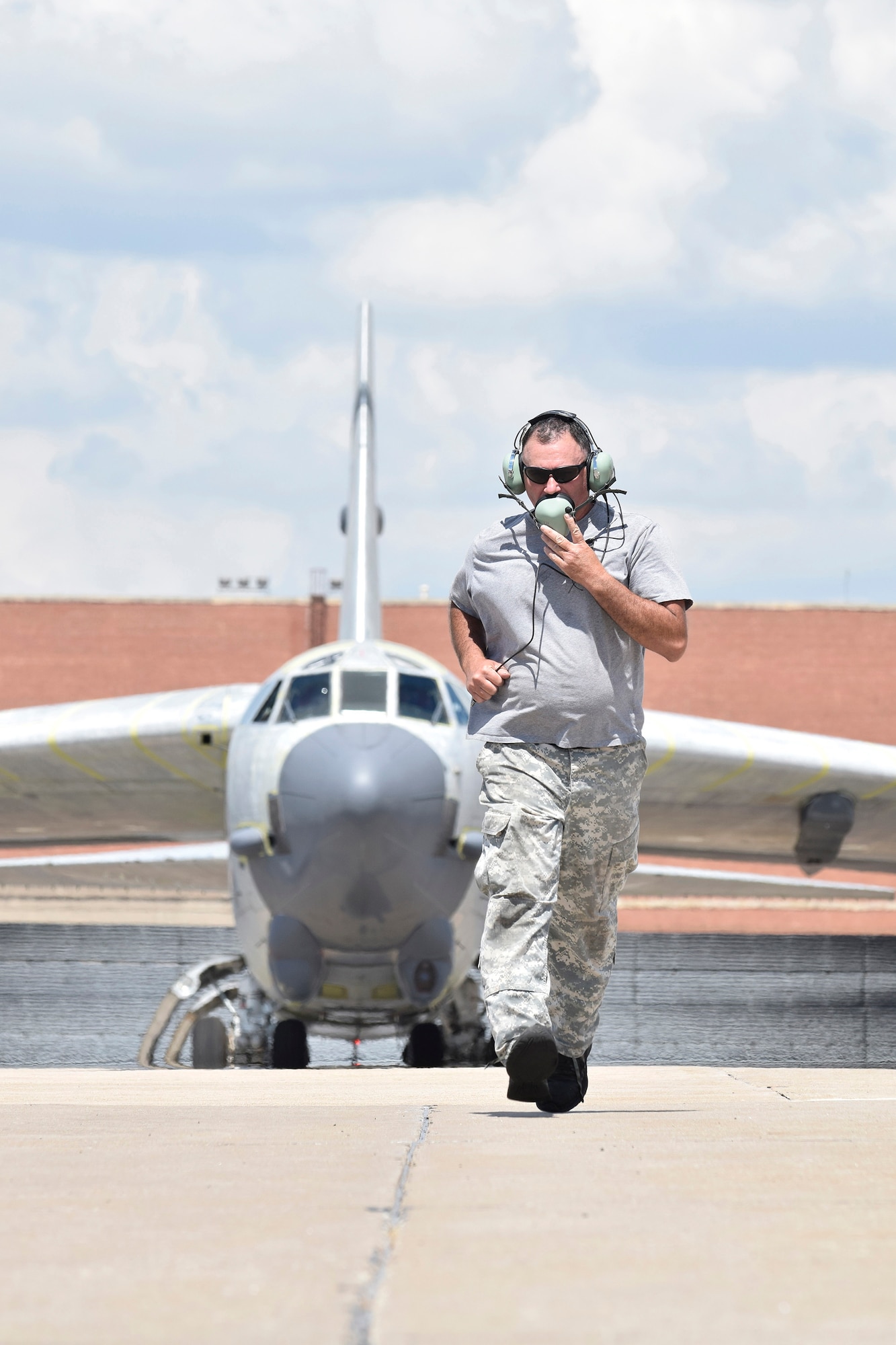 Mark Smith, 565th Aircraft Maintenance Squadron B-52H crew chief runs to position himself in front of B-52H 61-0007, 'Ghost Rider,' in order to launch the aircraft on an attempted functional test flight at the Oklahoma City Air Logistics Complex, Aug. 29, 2016, Tinker Air Force Base, Okla. 'Ghost Rider' is the first B-52H to ever be regenerated from long-term storage with the 309th Aerospace Maintenance and Regeneration Group at Davis-Monthan AFB, Ariz., and returned to fully-operational flying status. (U.S. Air Force photo/Greg L. Davis)