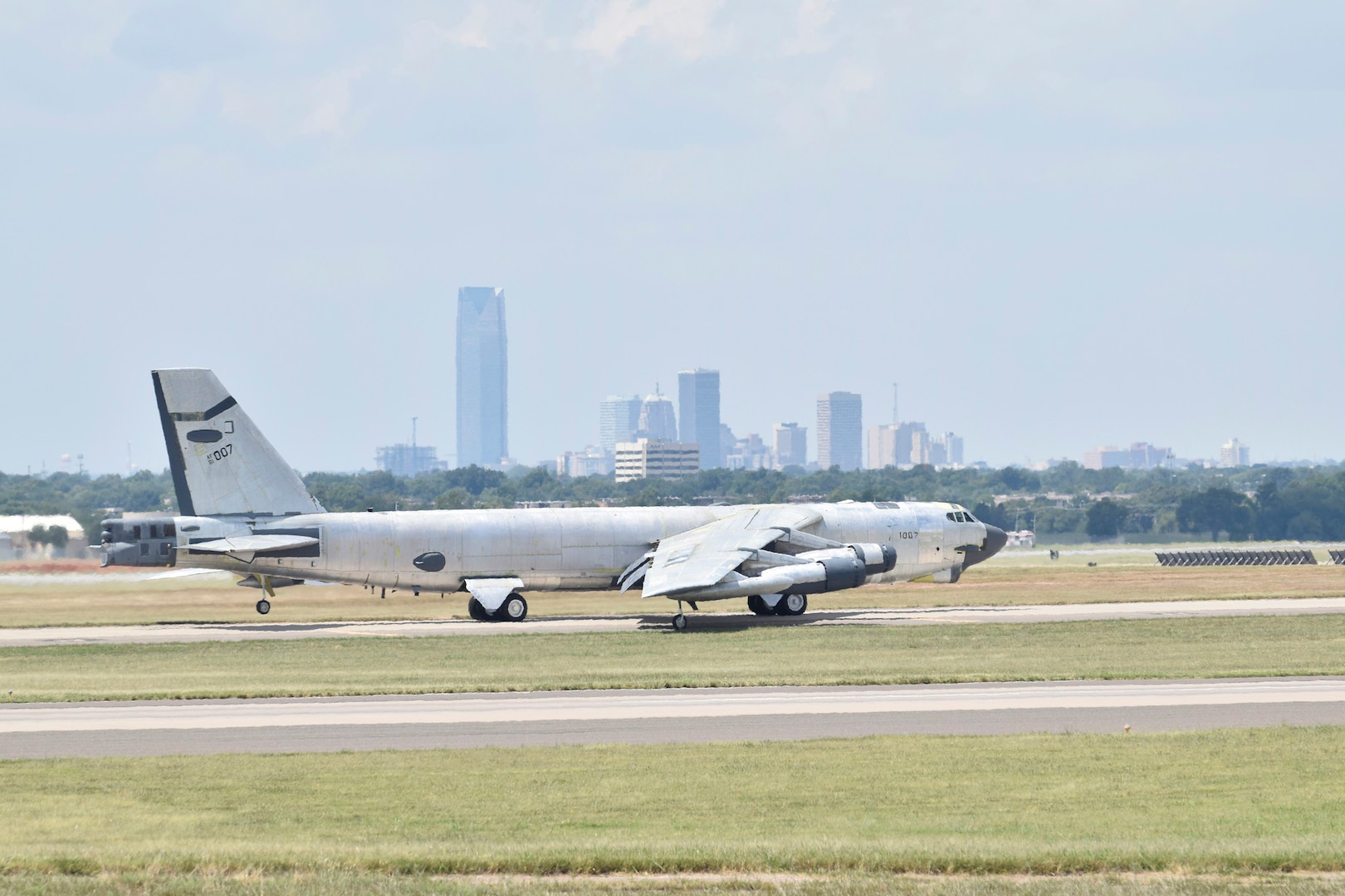 B-52H, 61-0007, 'Ghost Rider,' taxis with the skyline of Oklahoma City visible in the background before an attempted functional test flight after undergoing a 19-month overhaul and upgrade by the Oklahoma City Air Logistics Complex, Aug. 29, 2016, Tinker Air Force Base, Okla. 'Ghost Rider' is shown in natural metal since it has been overhauled and must be checked for full functionality before being painted. 61-0007 is the first B-52H to ever be regenerated from long-term storage with the 309th Aerospace Maintenance and Regeneration Group at Davis-Monthan AFB, Ariz., and returned to fully-operational flying status. (U.S. Air Force photo/Greg L. Davis)