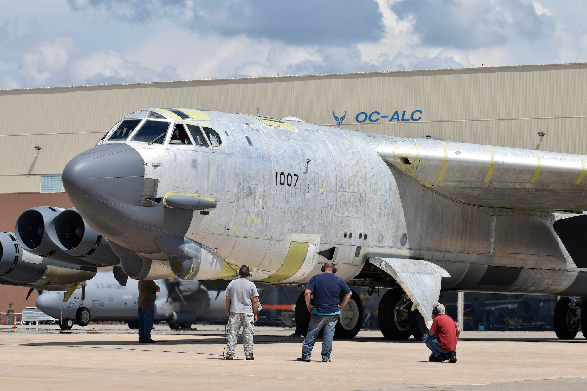 Maintenance personnel from the 565th Aircraft Maintenance Squadron work under and around B-52H 61-0007, 'Ghost Rider,' as the aircraft undergoes checks for an attempted functional test flight at the Oklahoma City Air Logistics Complex, Aug. 29, 2016, Tinker Air Force Base, Okla. 'OC-ALC' can be seen written on the hangar in the background as 'Ghost Rider' shines in natural metal as it completes a 19-month overhaul and upgrade to become the first B-52H to ever be regenerated from long-term storage with the 309th Aerospace Maintenance and Regeneration Group at Davis-Monthan AFB, Ariz., and returned to fully-operational flying status. (U.S. Air Force photo/Greg L. Davis)