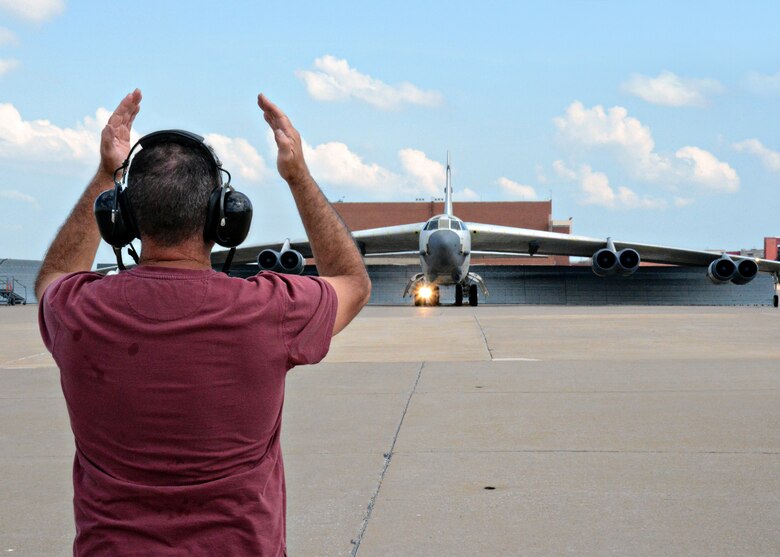 Mark Smith, 565th Aircraft Maintenance Squadron B-52H crew chief marshalls B-52H 61-0007, “Ghost Rider,” out from the chocks and run-up pad as the crew attempts to take the aircraft for a functional test flight after undergoing a 19-month overhaul and upgrade by the Oklahoma City Air Logistics Complex, Aug. 30, 2016, at Tinker Air Force Base, Okla. “Ghost Rider” is the first B-52H to ever be regenerated from long-term storage with the 309th Aerospace Maintenance and Regeneration Group at Davis-Monthan AFB, Ariz., and returned to fully-operational flying status. (U.S. Air Force photo by Kelly White)