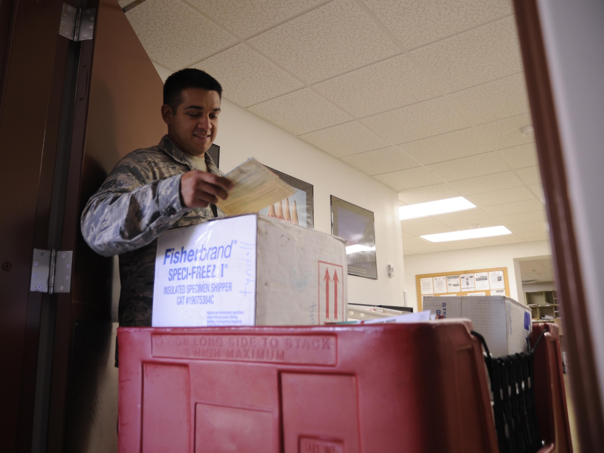 U.S. Air Force Senior Airman Jake Waters, 325th Communication Squadron Official Mail Center technician, receives a shipment from the United States Postal Service at the Official Mail Center Sept. 12, 2016. Technicians like Waters play a vital role in ensuring units receive official mail. (U.S. Air Force photo by Senior Airman Solomon Cook/Released)