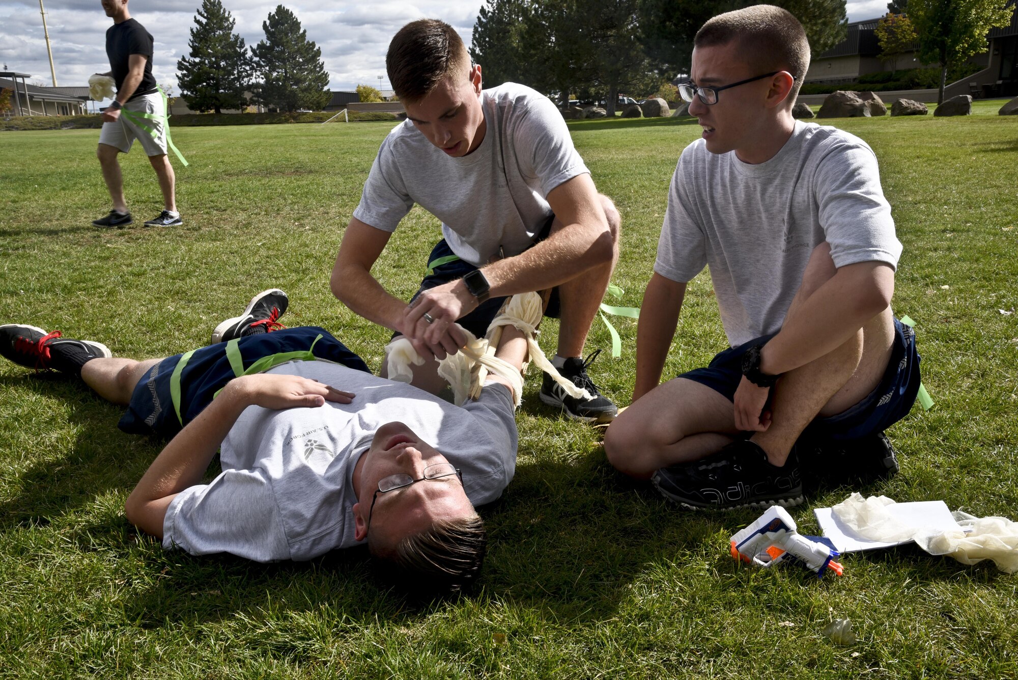 Airmen from the 92nd Comptroller Squadron team practice SABC during the Amazing Zombie Race Sept. 22, 2016, at Fairchild Air Force Base. Four-person teams competed against each other to complete basic preparedness and survival challenges, while also running from zombies. (U.S. Air Force photo/Airman 1st Class Taylor Shelton)