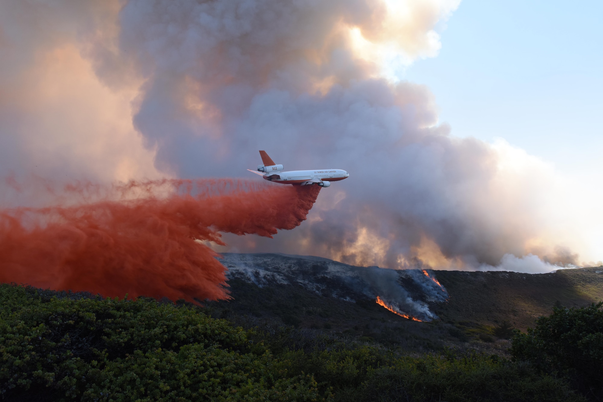 An aircraft drops fire retardant during a fire which swept through portions of South Base, Sept. 20, 2016, Vandenberg Air Force Base, Calif. Vandenberg personnel, alongside community partners and a specialized incident management team, have worked to extinguish five separate wildland fires, here, since Sept. 17. (U.S. Air Force photo by Staff Sgt. Shane Phipps/Released)