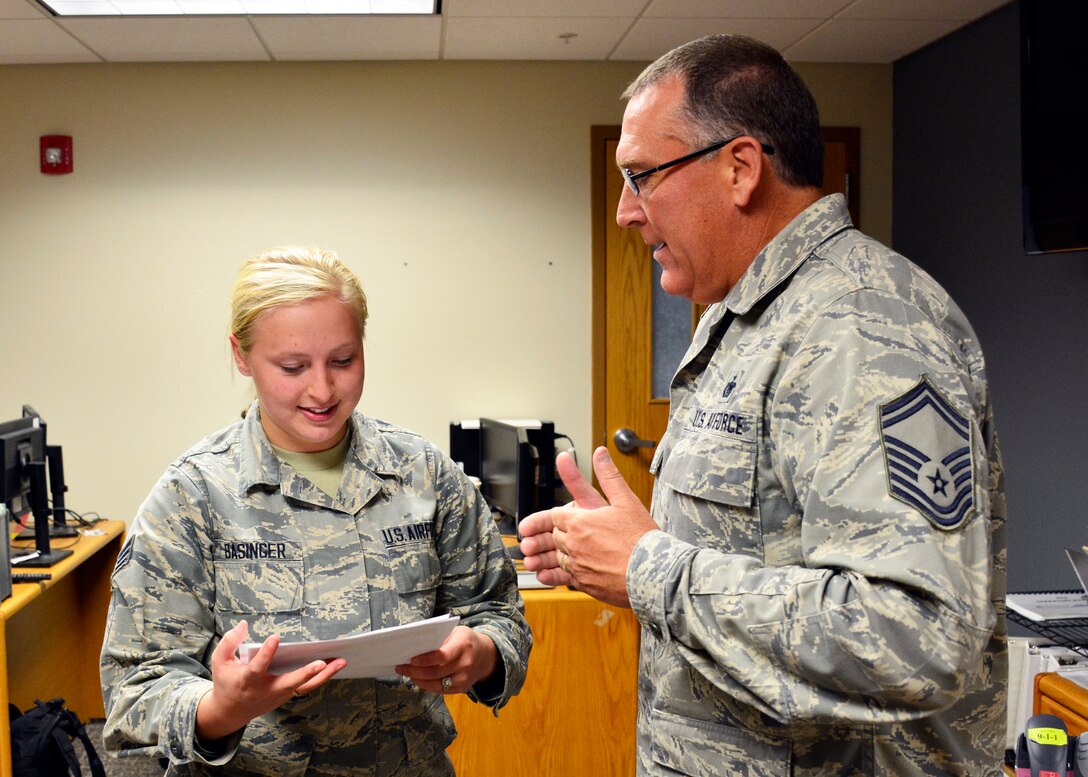 Military Personnel Section Customer Support Technician Senior Airman Brittany Basinger provides customer service to Senior Master Sgt. Theodore Clark during the regularly scheduled drill at the 120th Airlift Wing in Great Falls, Mont. Sept. 13, 2016. (U.S. Air National Guard photo by Senior Master Sgt. Eric Peterson)