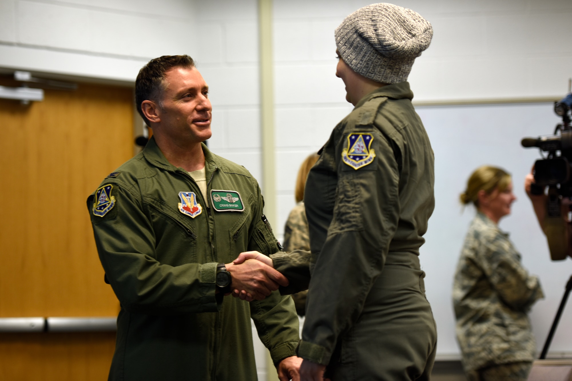U.S. Air Force Col. Craig R. Baker, the 180th Fighter Wing Commander, congratulates honorary 2nd Lt. Ashleigh Hunt after her commissioning ceremony May 26, 2016, at the 180FW in Swanton, Ohio. Hunt, who was diagnosed with osteosarcoma at 19, was honored during the first-ever Pilot for a Day event at the 180FW where she launched an F-16 Fighting Falcon, received a tour of the base facilities, and experienced basic pilot survival and parachute training. (U.S. Air National Guard photo by Staff Sgt. Shane Hughes)