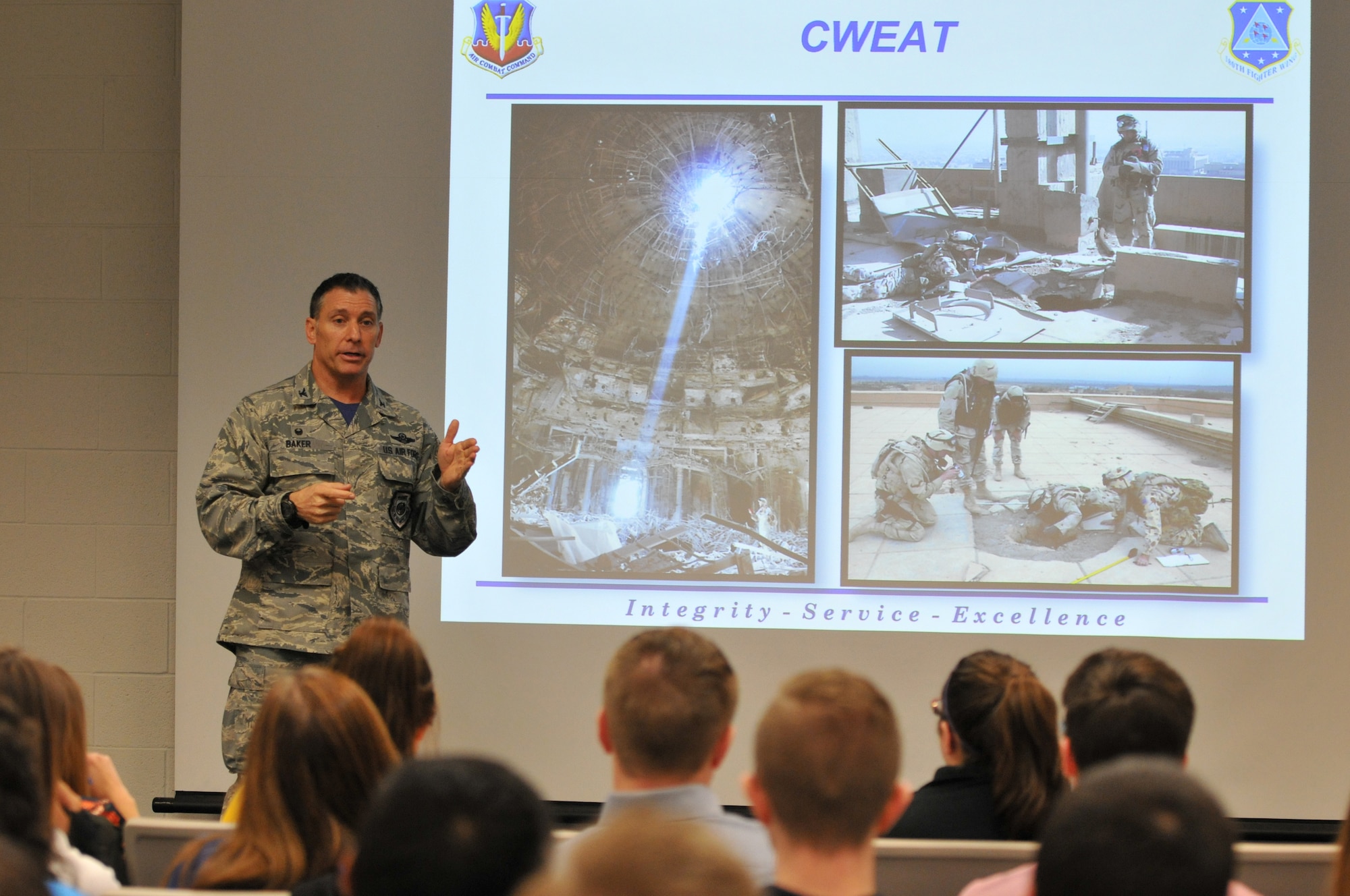 Col. Craig Baker, 180th Fighter Wing Commander, discusses effective leadership with students from University of Toledo's College of Business and Innovation, March 18, 2016. The college's honors students visited the wing to learn about military leadership and how it applies to mission success. Air National Guard photo by Staff Sgt. Shane Hughes. 