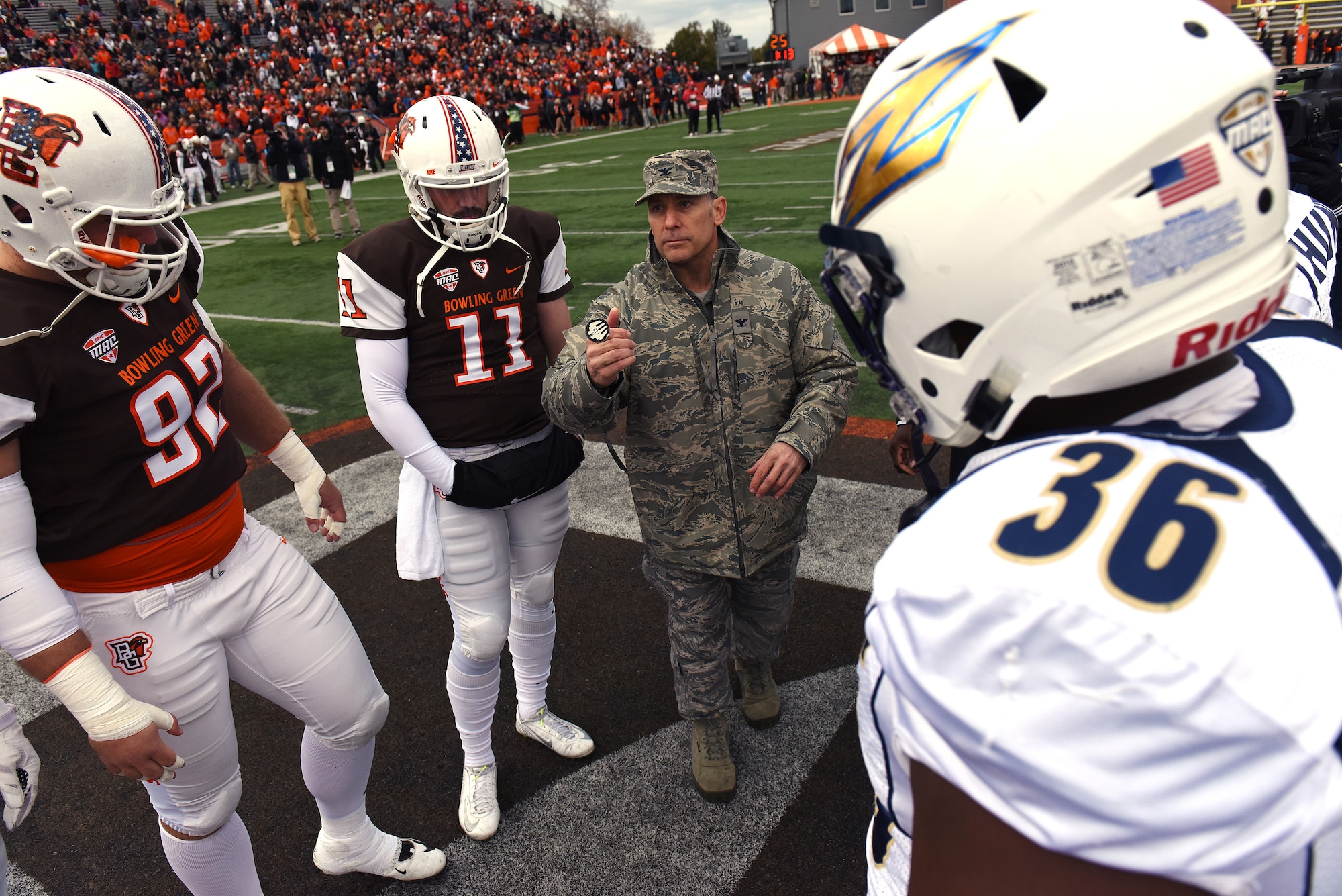 U.S. Air Force Col. Craig Baker, commander of the 180th Fighter Wing in Swanton, Ohio, performs the coin toss to start the Bowling Green State University Falcons Military Appreciation football game against the Akron Zips in Bowling Green, Ohio on Oct. 17, 2015. The Military Appreciation event, which was also the university’s homecoming game, was free for military members, highlighted veterans and their families on the field, and strengthened the community ties the 180th Fighter Wing strives to create. (Air National Guard photo by Tech. Sgt. Nic Kuetemeyer/released)