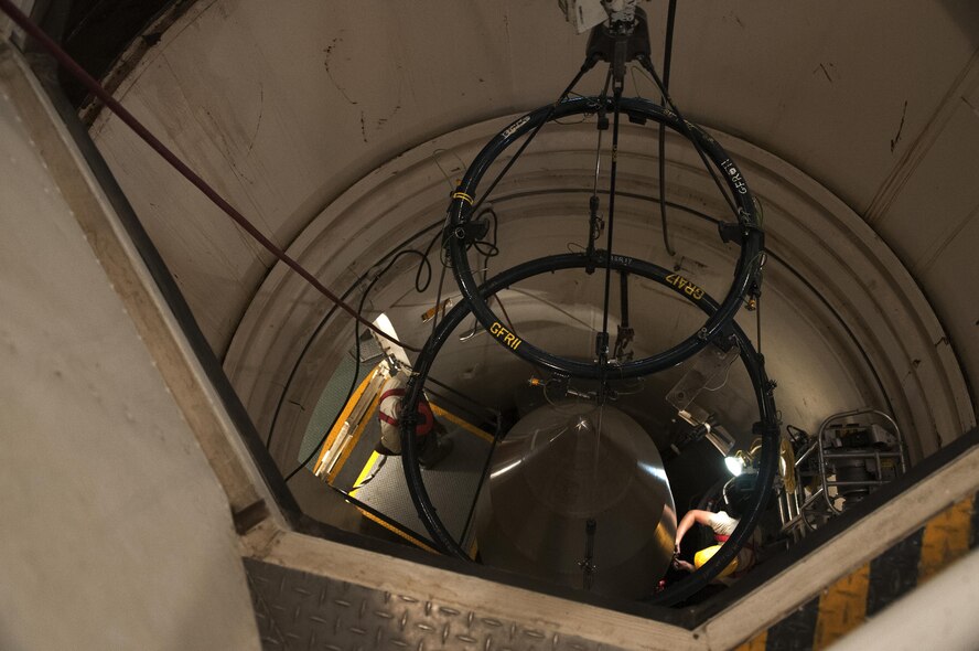 Two maintainers from the 90th Missile Maintenance Squadron prep the reentry system of a Minuteman III ICBM for removal from a launch facility in the F.E. Warren Air Force Base, Wyo., missile complex, Aug. 24, 2016. Airmen completed jobs in pairs, utilizing the two-man concept to ensure tasks were completed correctly and securely. The 90th MMXS maintains 150 Minuteman III ICBMs and the associated LFs spread throughout three states and 9,600 square miles. (U.S. Air Force photo by Senior Airman Brandon Valle)