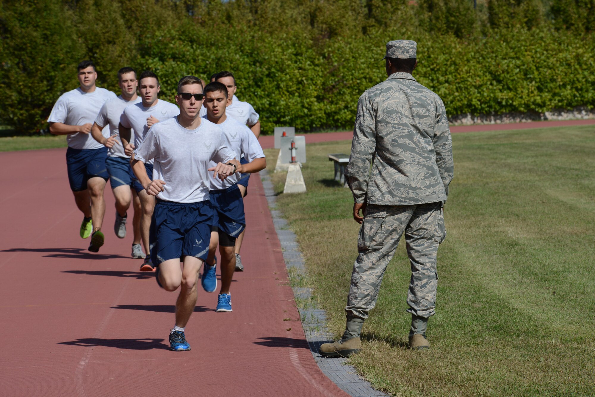 Airmen run 1,000 meters during the German Armed Forces Proficiency Badge competition at Aviano Air Base, Italy on Sept. 19, 2016. The Airmen competed in several basic fitness and marksmanship tests, ranging from a 100 meter swim, in uniform, to a ruck march. (U.S. Air Force photo by Staff Sgt. Andrew M. Satran/Released)
