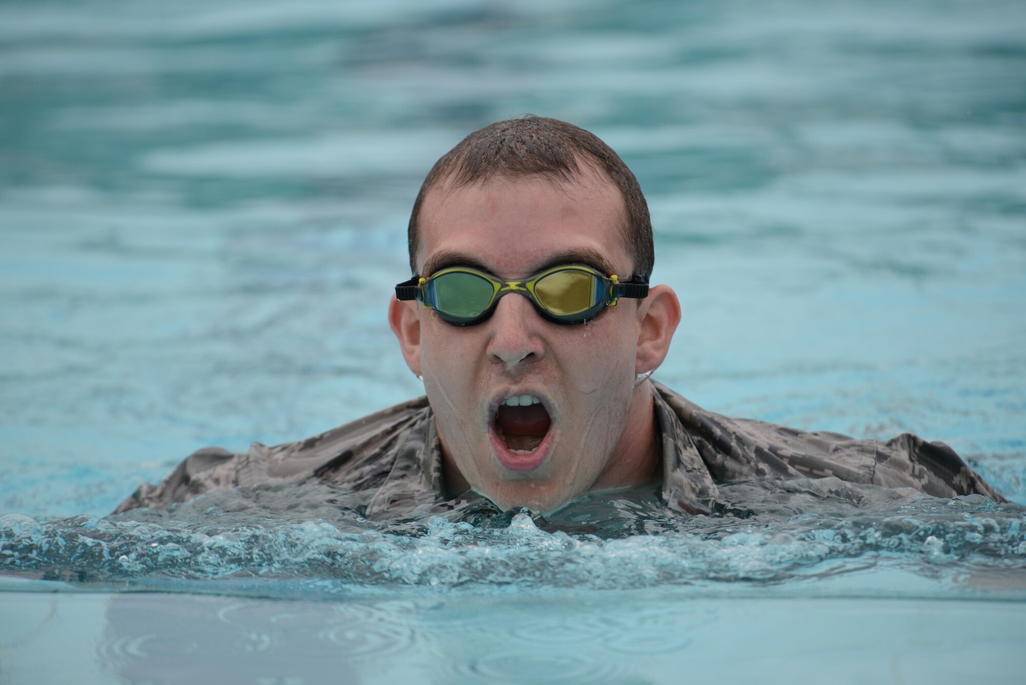 2nd Lt. Reilly Nuckel, 724th Air Mobility Squadron flight commander, swims 100 meters during the German Armed Forces Proficiency Badge competition at Aviano Air Base, Italy on Sept. 19, 2016. The swim required Airmen to wear their uniform and complete the test in under four minutes. (U.S. Air Force photo by Staff Sgt. Andrew M. Satran/Released)