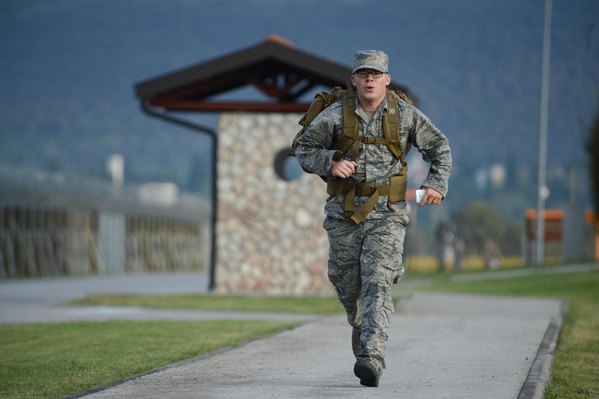 Staff Sgt. Ian Ginn, 31st Security Forces Squadron desk sergeant, completes a 9K road march during the German Armed Forces Proficiency Badge competition at Aviano Air Base, Italy on Sept. 19, 2016. Out of the 84 competitors, 65 were awarded a badge. (U.S. Air Force photo by Staff Sgt. Andrew M. Satran/Released)