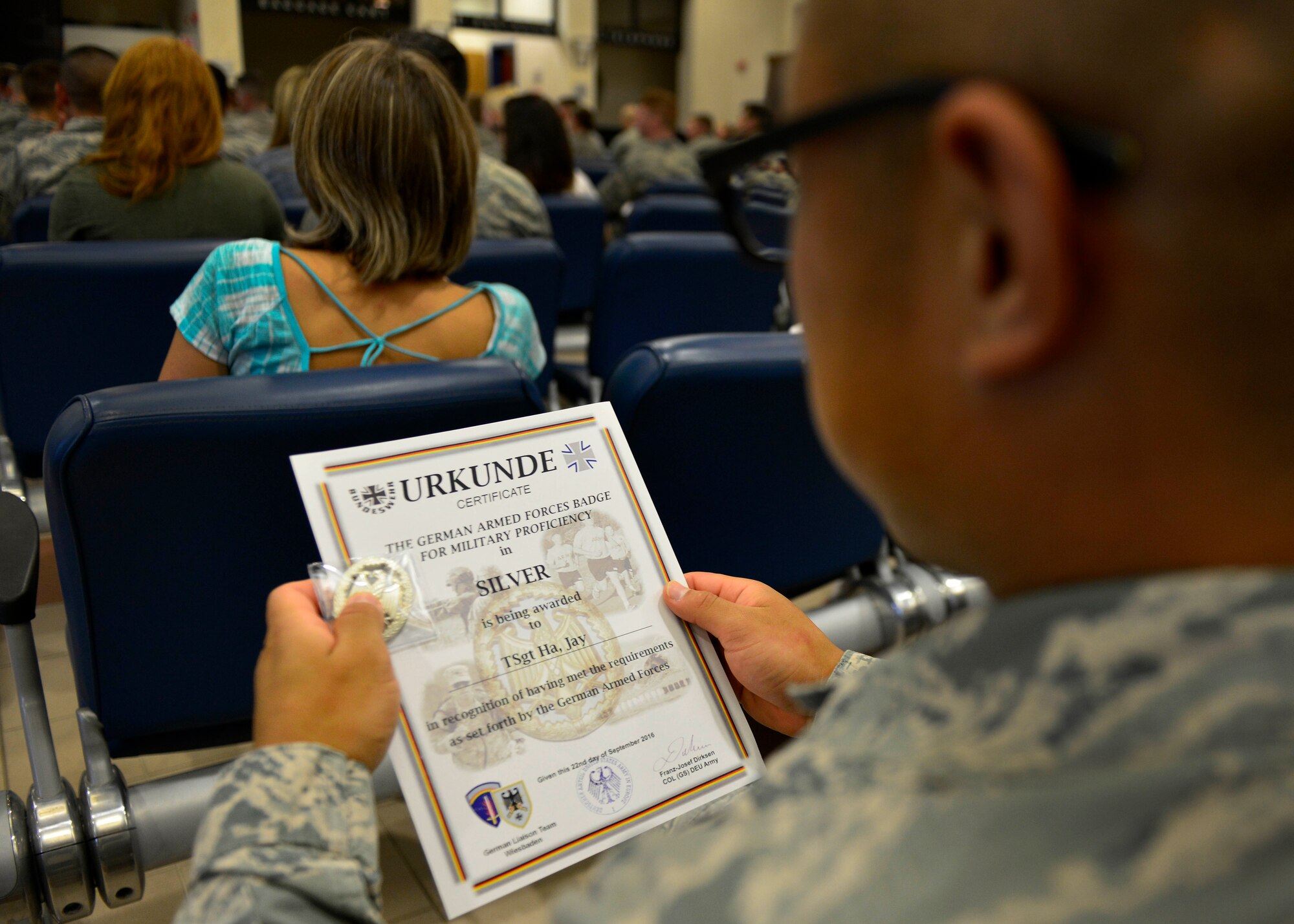 An Airman receives his silver German Armed Forces Proficiency Badge at Aviano Air Base, Italy on Sept. 19, 2016. Out of the 84 competitors, 65 were awarded a badge. Among them, 11 earned gold, 44 silver, and 10 earned bronze badges. (U.S. Air Force photo by Airman 1st Class Cary Smith/Released)