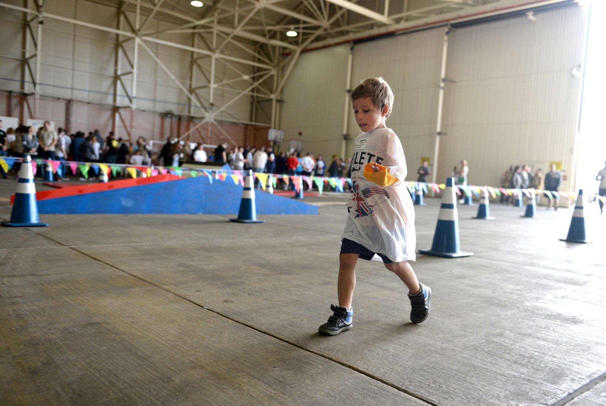 A child athlete participates in the 100-yard race during the 35th Annual Joan Mann Special Sports Day Sept. 24, 2016, on RAF Mildenhall, England. More than 500 volunteers, Airmen and dependents from RAF Mildenhall, RAF Lakenheath and RAF Feltwell made this event possible for more than 200 athletes. (U.S. Air Force photo by Staff Sgt. Kate Thornton)