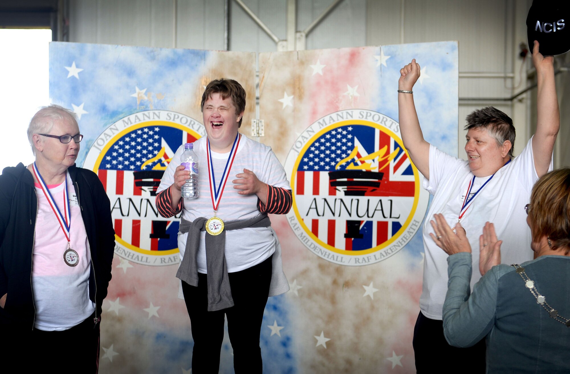 Athletes at the 35th Annual Joan Mann Special Sports Day  receive gold, silver, and bronze medals Sept. 24, 2016, on RAF Mildenhall, England. Joan Mann was a Ministry of Defence employee at RAF Mildenhall. She developed the special sports day as a way to offer people of all ages with special needs a day of fun and a way to bring the civilian and military communities closer. (U.S. Air Force photo by Staff Sgt. Kate Thornton)