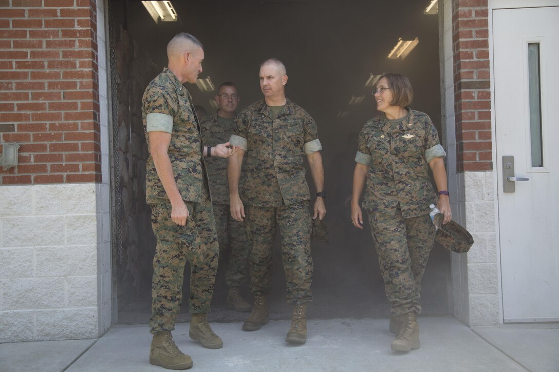 BGEN Bohm, Commanding Officer, Training Command, SgtMaj Monssen, Sergeant Major, Training Command, and CAPT Smith, Commanding Officer, Field Medical Training Battalion-East, exit the simulation lab.