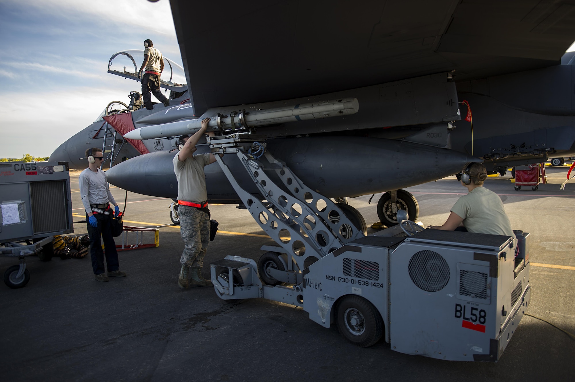 A three-man weapons load crew team, from the 48th Aircraft Maintenance Squadron, load an AIM-120 onto an F-15E Strike Eagle after a sortie in support of Tactical Leadership Programme 16-3 at Los Llanos Air Base, Spain, Sept. 19. Training programs like TLP showcase how the U.S. works side-by-side with NATO Allies and partners every day, training to meet future security challenges as a unified force. (U.S. Air Force photo/ Staff Sgt. Emerson Nuñez)