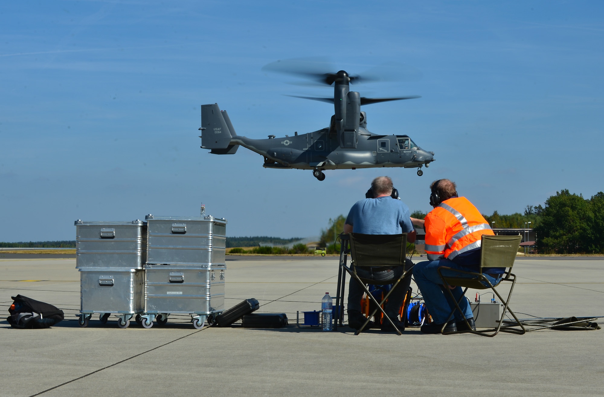 Local sound engineers watch and listen as a U.S. Air Force CV-22 Osprey Aircraft, assigned to the 352nd Special Operations Wing, Royal Air Force Mildenhall, England hovers over the flightline at Spangdahlem Air Base, Germany, Sept. 21, 2016. The engineers performed acoustic testing on the CV-22 at Spangdahlem from Sept. 20-23.  (U.S. Air Force photo by 1st Lt. Meredith Mulvihill)
