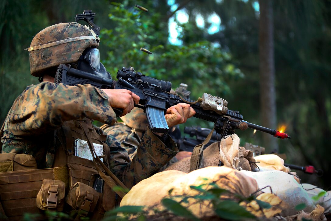 Marine Corps infantry squad leaders return fire while defending their position during the advanced infantry course at Kahuku Training Area, Hawaii, Sept. 21, 2016. Marine Corps photo by Cpl. Aaron S. Patterson