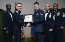 Senior Airman Alexander Franco, a communications security accountant assigned to the 5th Communications Squadron, accepts an award during his Airman Leadership School graduation May 5, 2016. Franco was awarded the John L. Levitow award for his leadership skills and academic achievements. (U.S. Air Force photo/Staff Sgt. Chad Trujillo)