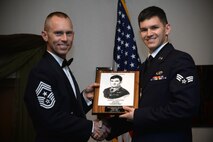 Senior Airman Alexander Franco, a communications security accountant assigned to the 5th Communications Squadron, accepts an award during his Airman Leadership School graduation May 5, 2016. Franco was awarded the John L. Levitow award for his leadership skills and academic achievements. (U.S. Air Force photo/Staff Sgt. Chad Trujillo)