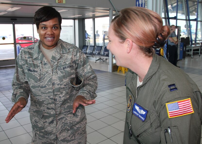 The 932nd Airlift Wing's Operation Group executed the mission by sending out members of the Aeromedical Evacuation Squadron to another deployed location recently, with help from the wing commander, the operations group commander, and 932nd Aeromedical Evacuation Squadron leaders like Master Sgt. Kelly Willis (left) and Captain Lindsay Barnes (right) .  They helped carry bags, greeted families and shared a laugh at the Saint Louis airport.   (U.S. Air Force photo by Maj. Stan Paregien)