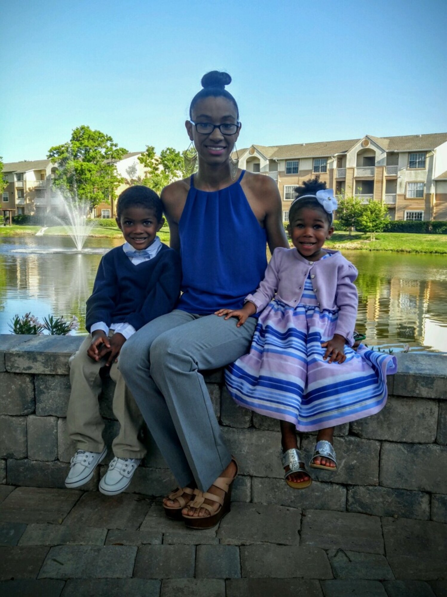 Senior Airman Jenay Randolph, a photojournalist assigned to the 6th Air Mobility Wing Public Affairs office, poses for a picture with her children, May 30, 2016 at MacDill Air Force Base, Fla. Randolph is a single mother of two and uses the lessons she had learned over the years to overcome any challenges she is faced with. (Courtesy Photo)