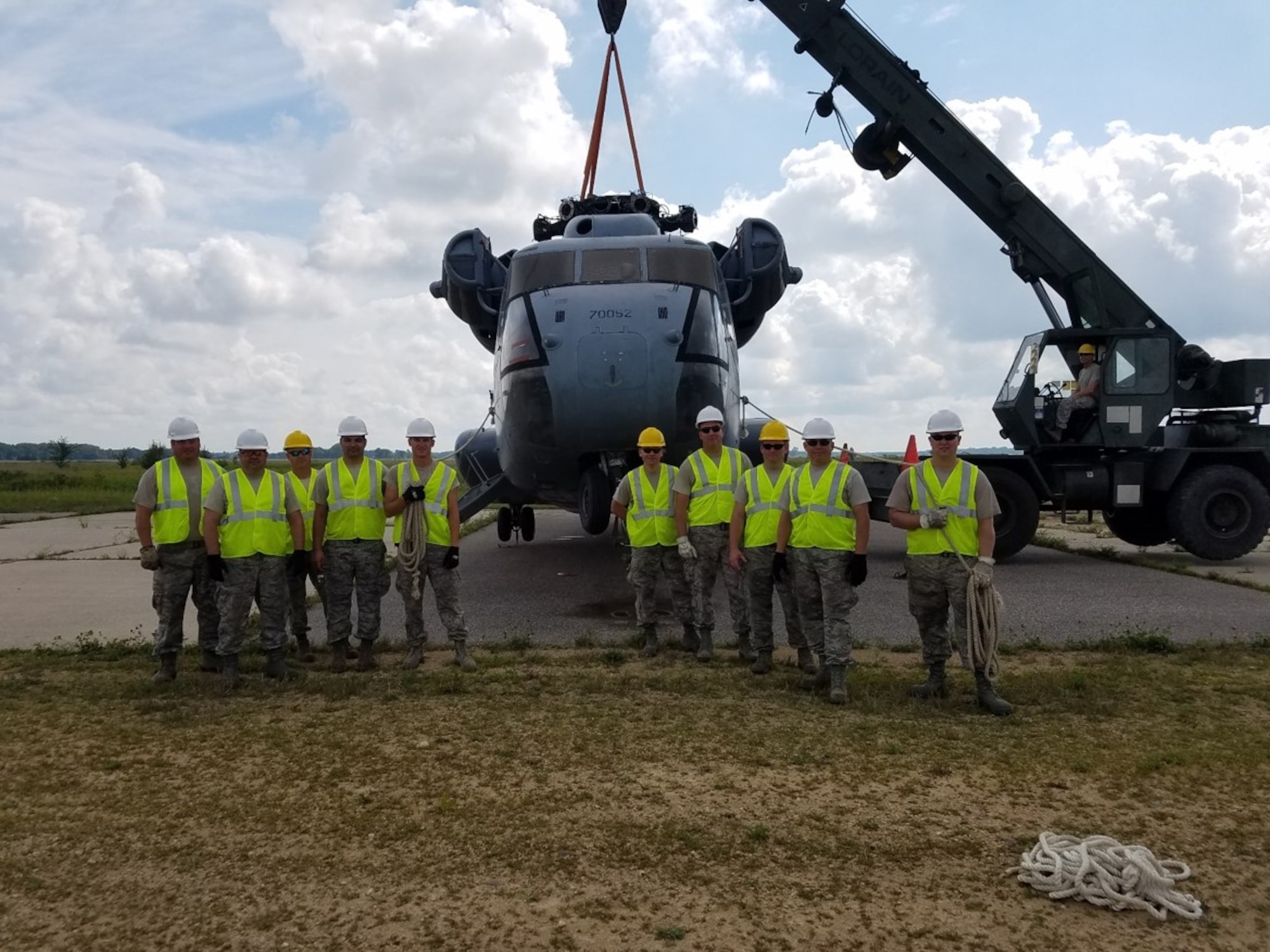 CDDAR team members from the 934th Airlift Wing and 133rd Minnesota Air National Guard pose near the Sikorsky MH 53 they were required to move during the exercise.
