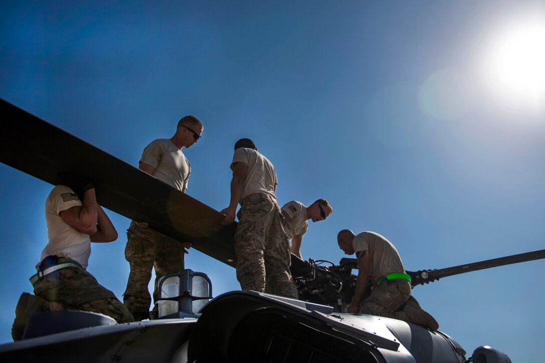 Airmen unfold the blades of an HH-60G Pave Hawk helicopter at Bagram Airfield, Afghanistan, Sept. 26, 2016. The airmen, assigned to the 83rd Expeditionary Rescue Squadron, provide the only U.S. personnel recovery assets in Afghanistan. Air Force photo by Senior Airman Justyn M. Freeman