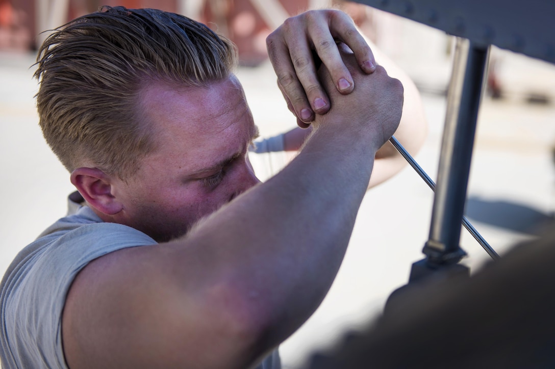 Air Force Airman 1st Class Brian Krachc unfolds a stab on an HH-60G Pave Hawk helicopter at Bagram Airfield, Afghanistan, Sept. 26, 2016. Krachc is a crew chief assigned to the 83rd Expeditionary Rescue Squadron. The stab on the helicopter keeps the pitch access level during flight and helps maintain balance. Air Force photo by Senior Airman Justyn M. Freeman