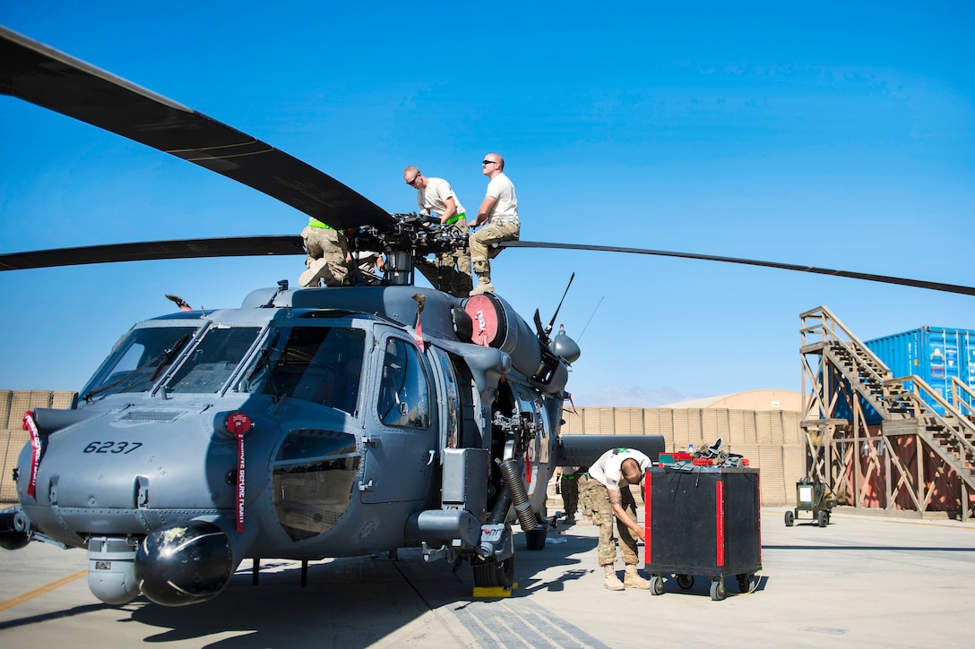 Airmen perform maintenance on the main rotor blades of an HH-60G Pave Hawk helicopter at Bagram Airfield, Afghanistan, Sept. 26, 2016. Air Force photo by Senior Airman Justyn M. Freeman