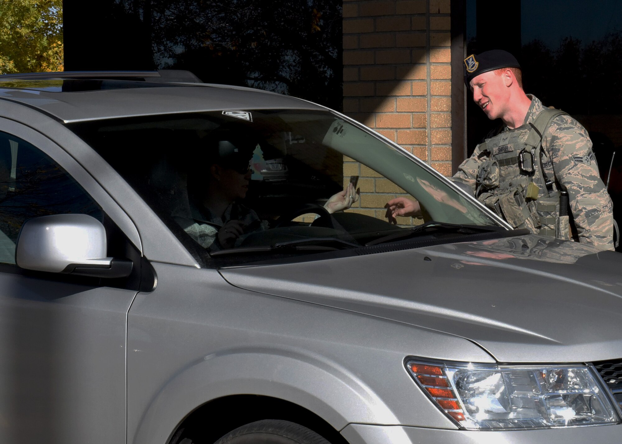 Airman 1st Class John Shirah, 341st Security Forces Support Squadron, checks ID cards at Malmstrom Air Force Base, Mont., Sept. 26, 2016.  It’s these types of security measures, as well as the Eagle Eyes Program, an OSI initiative, that helps prevent hostile acts against service members, their families and Department of Defense assets.  Any service members, families or DOD personnel can report suspicious activities by calling the 24-hour hotline at 406-731-3895. (U.S. Air Force photo/Jason Heavner)