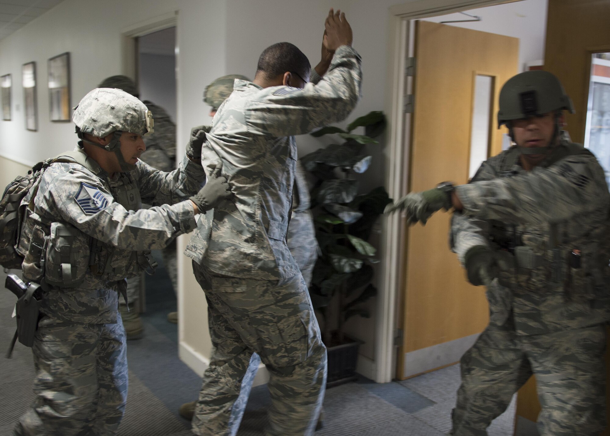 Security forces members evacuate personnel from building 1035 during an active shooter exercise at Royal Air Force Lakenheath, England Sept. 22. As a precaution, building personnel were searched during the evacuation, after the immediate threat was eliminated. (U.S. Air Force photo/Senior Airman Malcolm Mayfield)