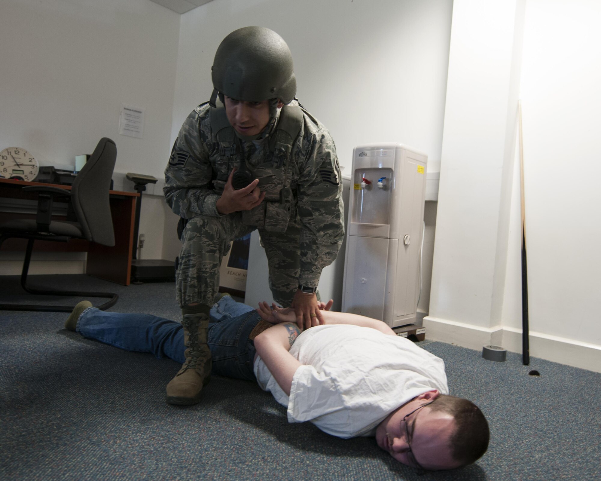 U.S. Air Force Staff Sgt. Christian Varela, 48th Security Forces Squadron response force leader, secures a simulated active shooter during an exercise at Royal Air Force Lakenheath, England, Sept. 22. These exercises are conducted bi-annually, in order to ensure all personnel are properly trained to respond accordingly to an active shooter situation. (U.S. Air Force photo/Senior Airman Malcolm Mayfield)