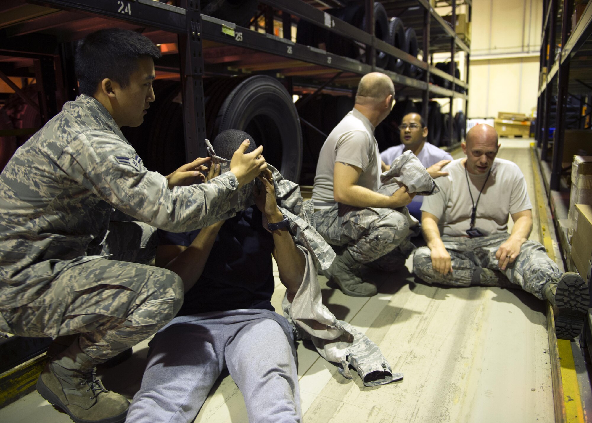 Airmen provide self-aid buddy care during an active shooter exercise at Royal Air Force Lakenheath, England, Sept. 22. The 48th Security Forces Squadron responders requested bystanders to step up and assist as they continued their sweep further into the building. (U.S. Air Force photo/Senior Airman Malcolm Mayfield)