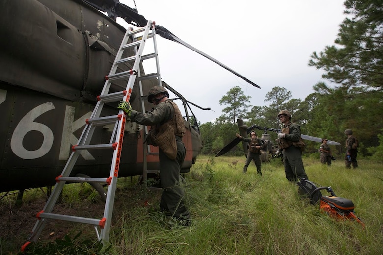 Marines rehearse salvaging an aircraft during a field exercise aboard Marine Corps Outlying Field Camp Davis, N.C., Sept. 22, 2016. Support squadrons across the Marine Corps conduct these exercises to remain ready for any challenge they may face in forward deployed environments. This exercise featured training that included auxiliary airfield construction, ground security and airfield damage repair. The squadron's capabilities contribute to 2nd Marine Aircraft Wing's role in the Marine Air Ground Task Force's mission accomplishment. The Marines participating in the exercise are assigned to Marine Wing Support Squadron 274, Marine Aircraft Group 29, 2nd MAW. (U.S. Marine Corps photo by Sgt. N.W. Huertas/Released) 